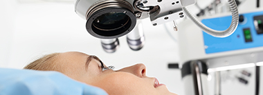 a woman having a microscope over her eye